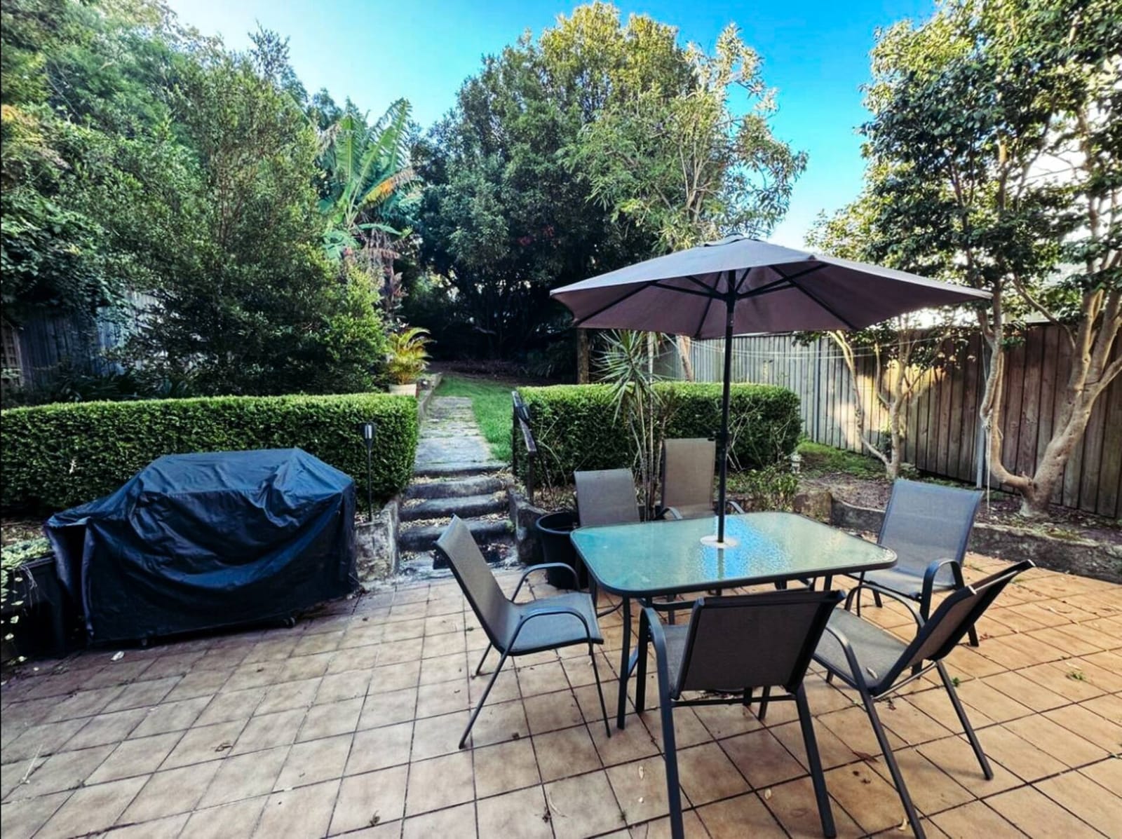 Back patio, outdoor table and chairs under cover