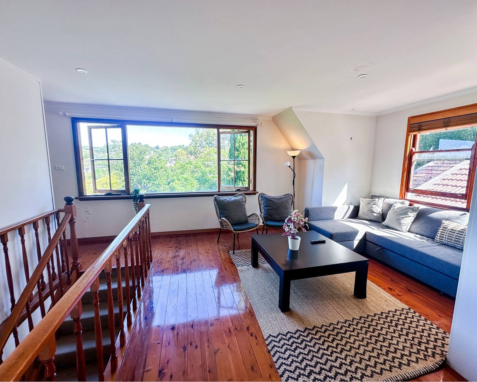 Upstairs lounge, blue sofa and a view over the water